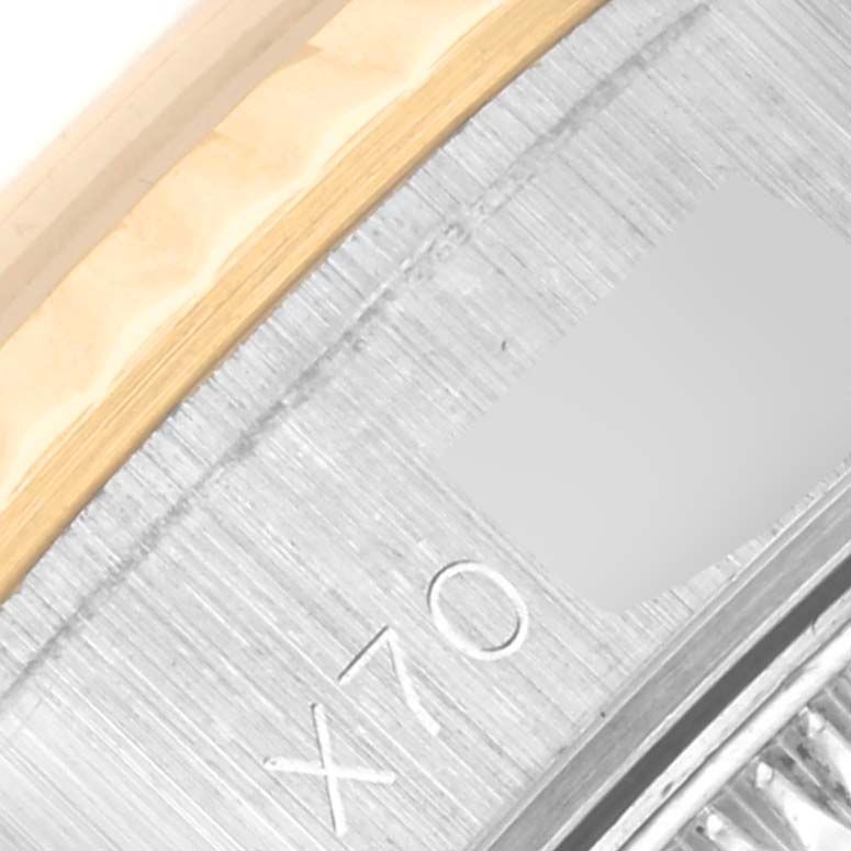 The image shows a close-up of a Rolex Datejust 69173 Women
s Steel and Gold (two tone) Champagne Dial 69173 Women
s Steel and Gold (two tone) Champagne Dial watch case side, displaying the brushed metal finish and part of the bezel.