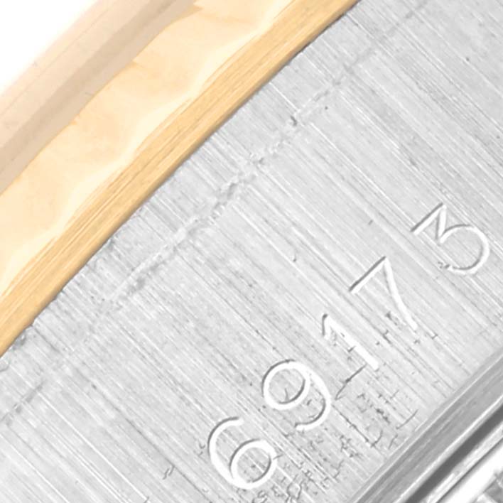 The image shows a close-up of the side of the Rolex Datejust 69173 Women
s Steel and Gold (two tone) Champagne Dial 69173 Women
s Steel and Gold (two tone) Champagne Dial, highlighting the bezel and part of the brushed metal case.