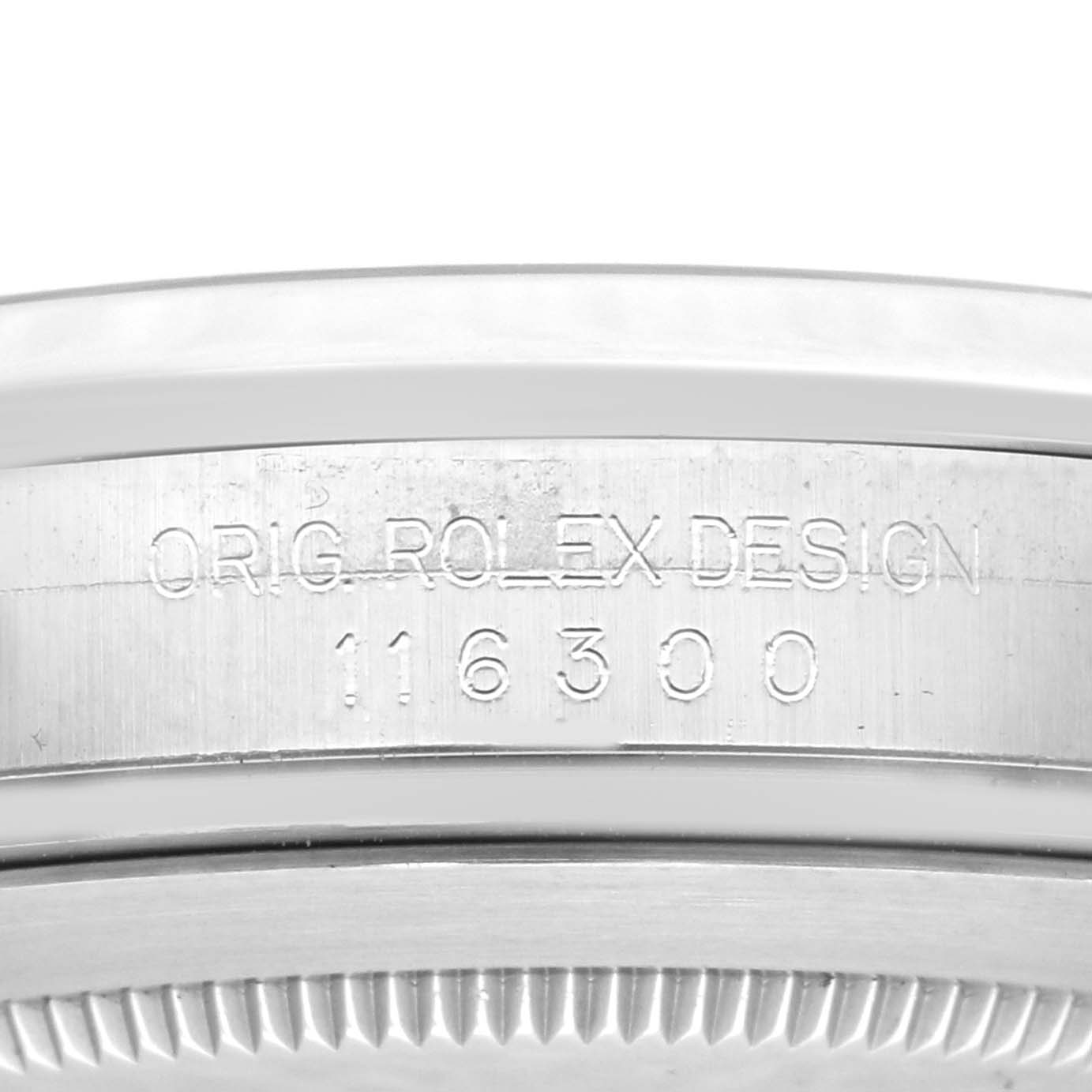 The image shows the side engraving of a Rolex Datejust 41 116300 Men
s Stainless Steel Blue Dial 116300 Men
s Stainless Steel Blue Dial, displaying "ORIG ROLEX DESIGN" and a reference number.