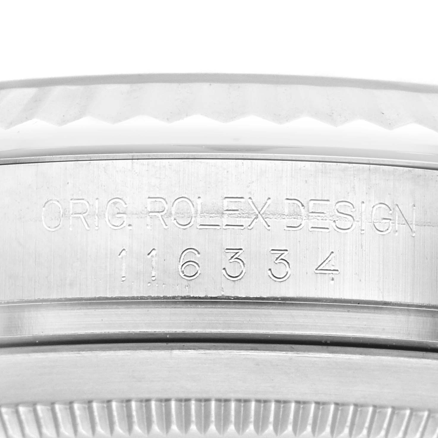 The image shows a close-up of the side of a Rolex Datejust 41 116334 Men
s Stainless Steel Black Dial 116334 Men
s Stainless Steel Black Dial case with engravings.