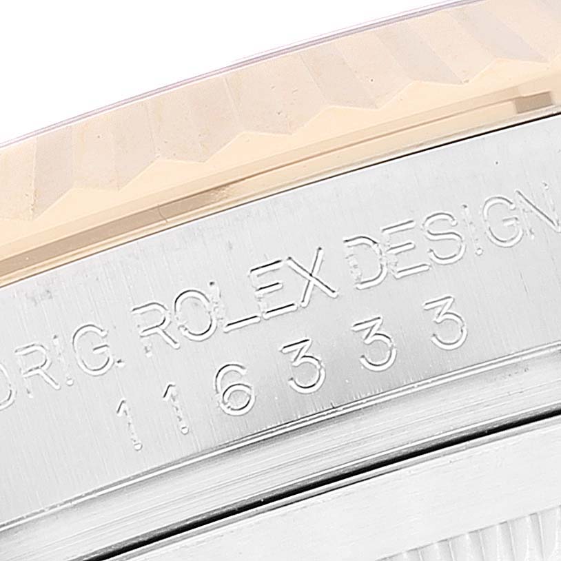 This image shows a close-up of the engraved serial number and "Rolex Design" text on the bezel edge of a Rolex Datejust 116333 Men
s Steel and Gold (two tone) Black Dial 116333 Men
s Steel and Gold (two tone) Black Dial watch.