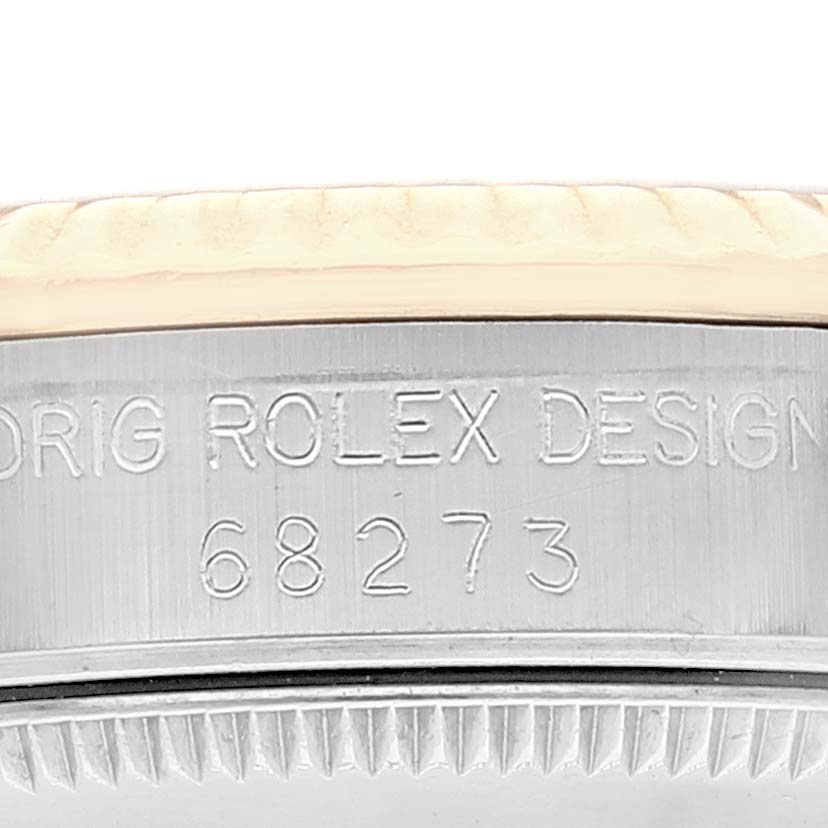This image shows a close-up of the side of a Rolex Mid-Size 68273 Women
s Steel and Gold (two tone) Champagne Dial 68273 Women
s Steel and Gold (two tone) Champagne Dial model watch case with the model number 68273 engraved.