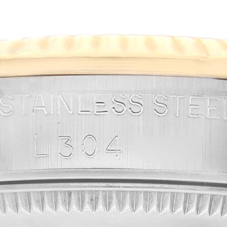 This close-up shows the engraved stainless steel case and bezel of the Mid-Size Rolex watch.