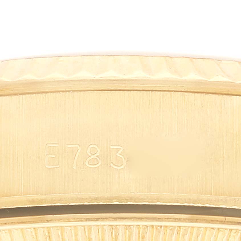This image shows a close-up of the side and part of the bezel of a Rolex President 69178 Women's Yellow Gold Champagne Dial 69178 Women's Yellow Gold Champagne Dial model watch, including its serial number.