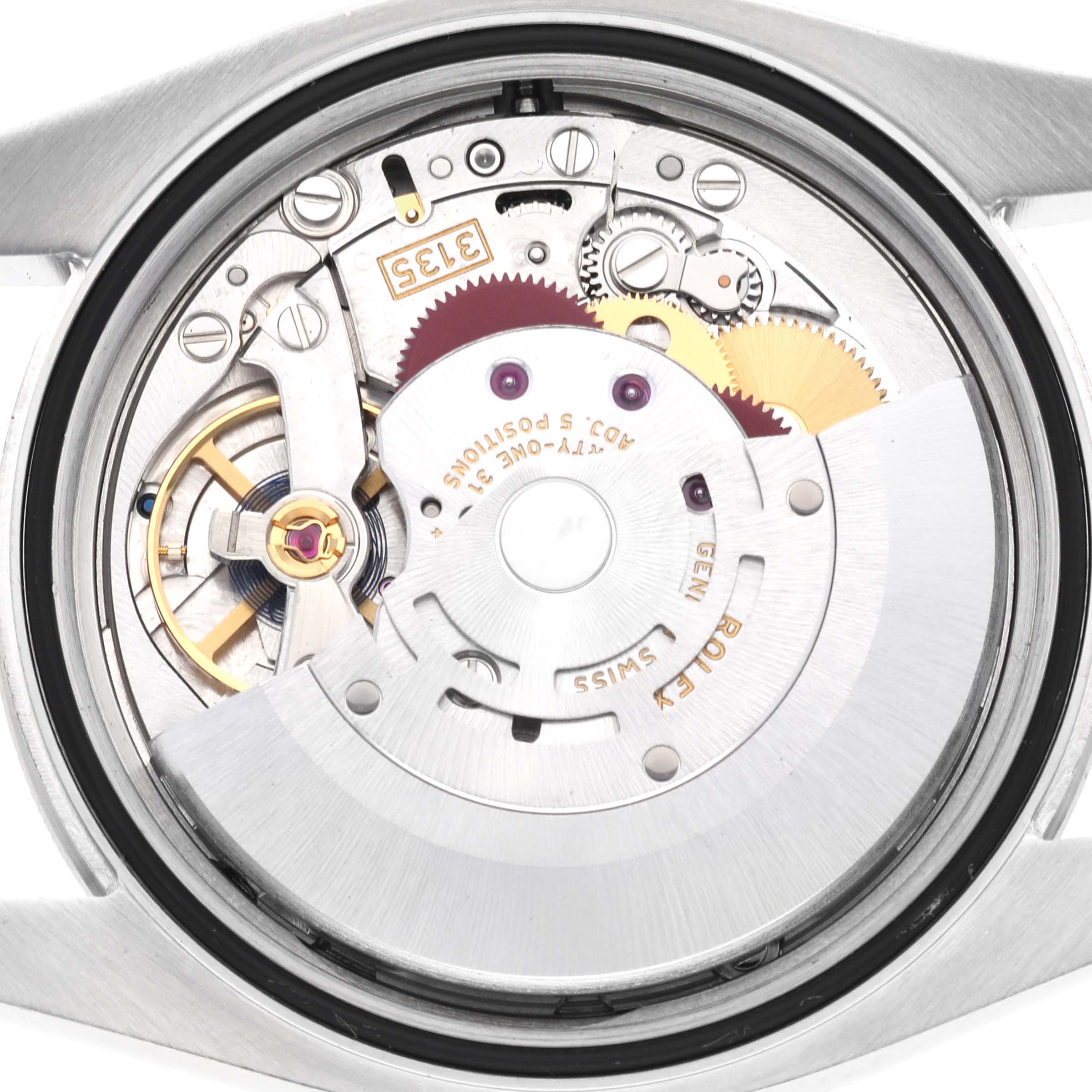 The image shows the inner mechanical movement of the Rolex Datejust 116244 Men's Stainless Steel Silver Dial 116244 Men's Stainless Steel Silver Dial watch from a back view, displaying gears and components.