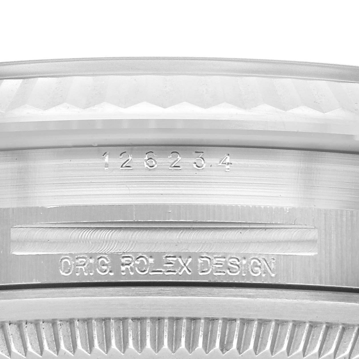 The image shows a close-up of the Rolex Datejust 126234 Men's Stainless Steel Blue Dial 126234 Men's Stainless Steel Blue Dial's side with its engraved model number and "Orig. Rolex Design" text.