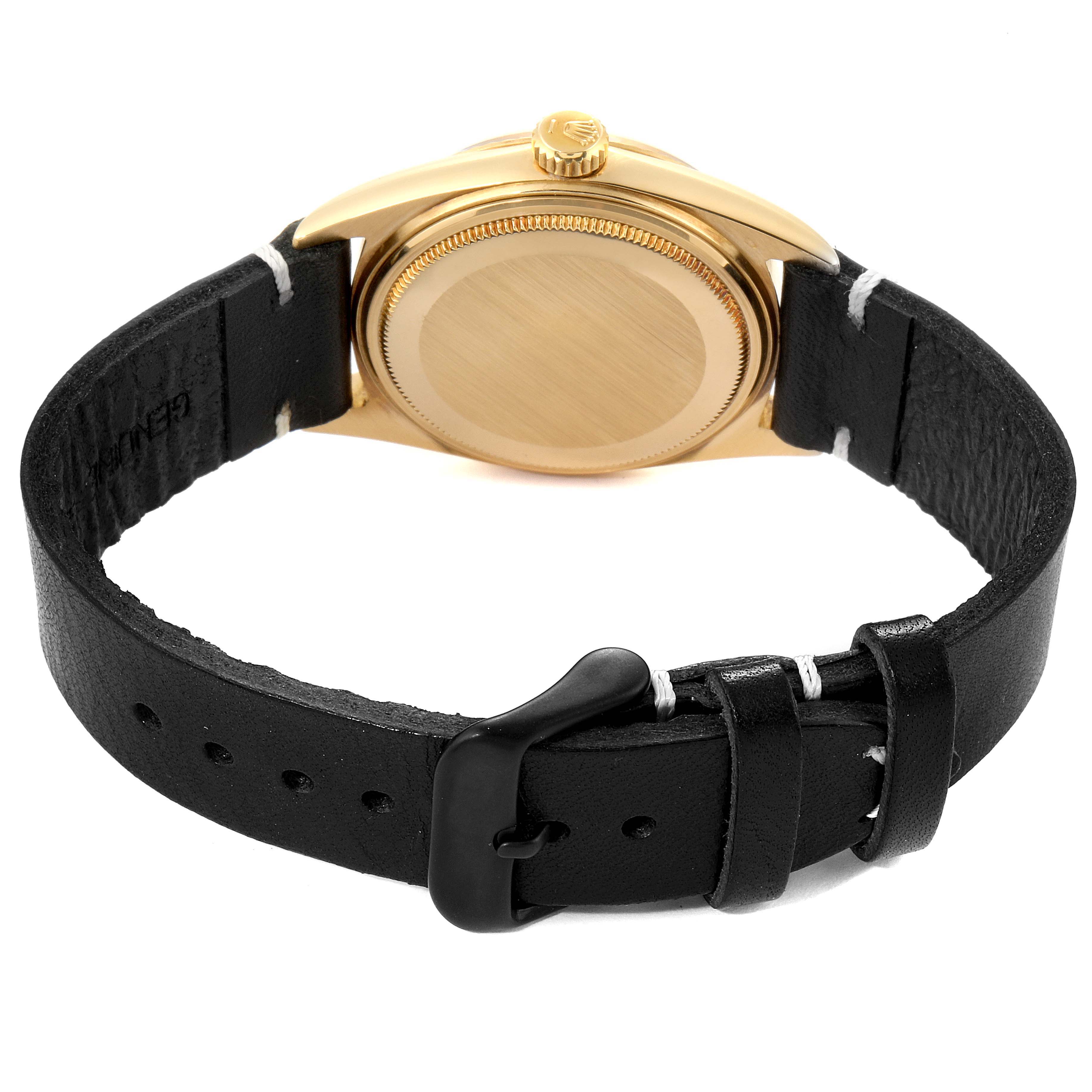 The image shows the back view of a Rolex Datejust 1601 Men's Yellow Gold Black Dial 1601 Men's Yellow Gold Black Dial watch, featuring its case, crown, and black leather strap with a buckle.