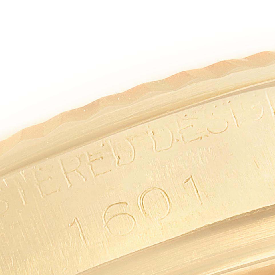 This is a close-up shot of the bezel and case side of the Rolex Datejust 1601 Men's Yellow Gold Black Dial 1601 Men's Yellow Gold Black Dial model, showing part of its serial number.