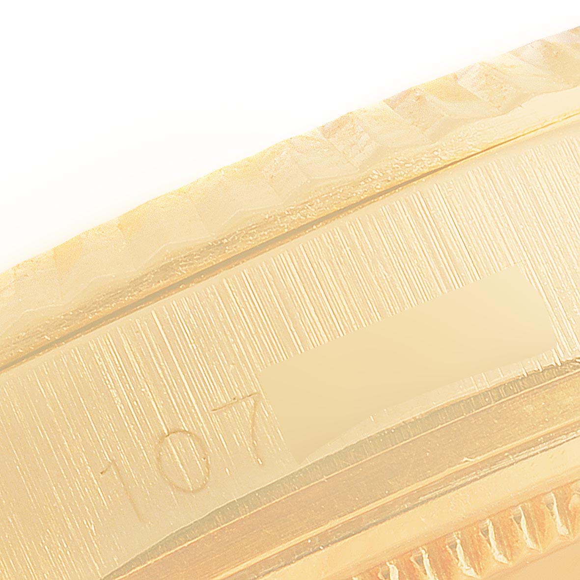 This close-up image shows a portion of the bezel and serial number area of a Rolex Datejust 1601 Men's Yellow Gold Black Dial 1601 Men's Yellow Gold Black Dial watch.