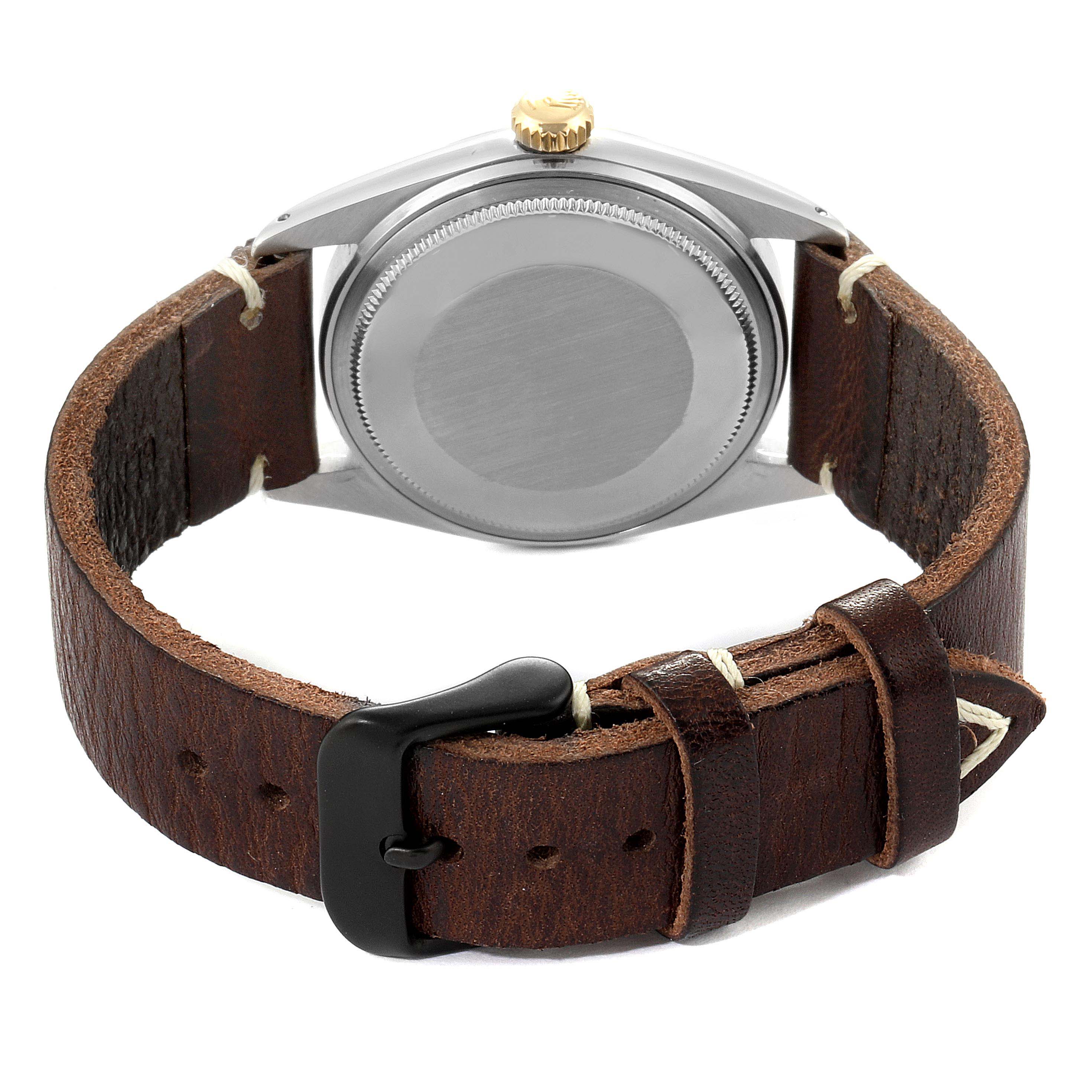 The image shows the back view of a Rolex Datejust 1601 Men's Stainless Steel Champagne Dial 1601 Men's Stainless Steel Champagne Dial watch with its case back and a brown leather strap.