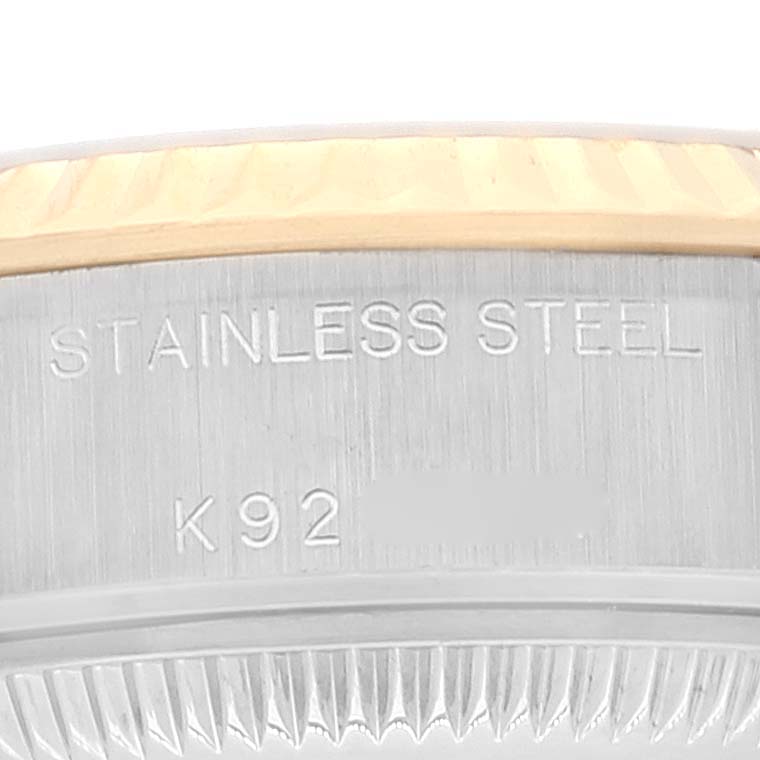 This image shows a close-up of the side of the Rolex Datejust 79173 Women's Steel and Gold (two tone) Champagne Dial 79173 Women's Steel and Gold (two tone) Champagne Dial watch case, featuring stainless steel and engraving.