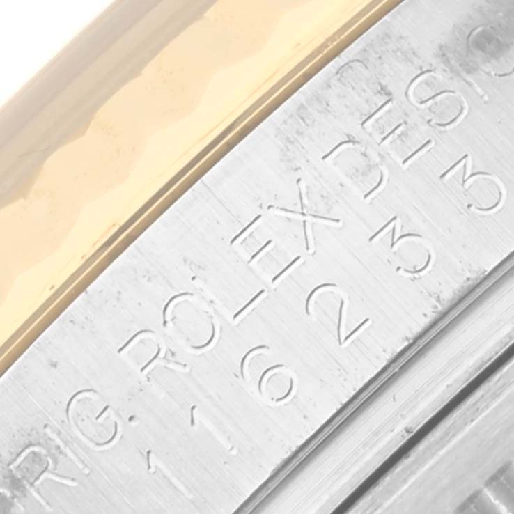 This image shows a close-up of the Rolex Datejust 116233 Men's Steel and Gold (two tone) Champagne Dial 116233 Men's Steel and Gold (two tone) Champagne Dial model's engraved bezel and gold edge.