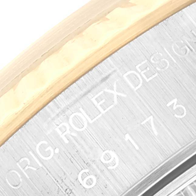 This close-up image shows the engraving on the back case of a Rolex Datejust 69173 Women's Steel and Gold (two tone) Mother of Pearl Dial 69173 Women's Steel and Gold (two tone) Mother of Pearl Dial watch.
