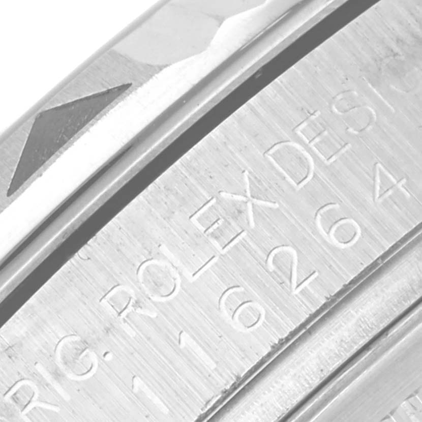 The image shows a close-up of the side engraving on a Rolex Datejust 116264 Men's Stainless Steel Blue Dial 116264 Men's Stainless Steel Blue Dial bezel.