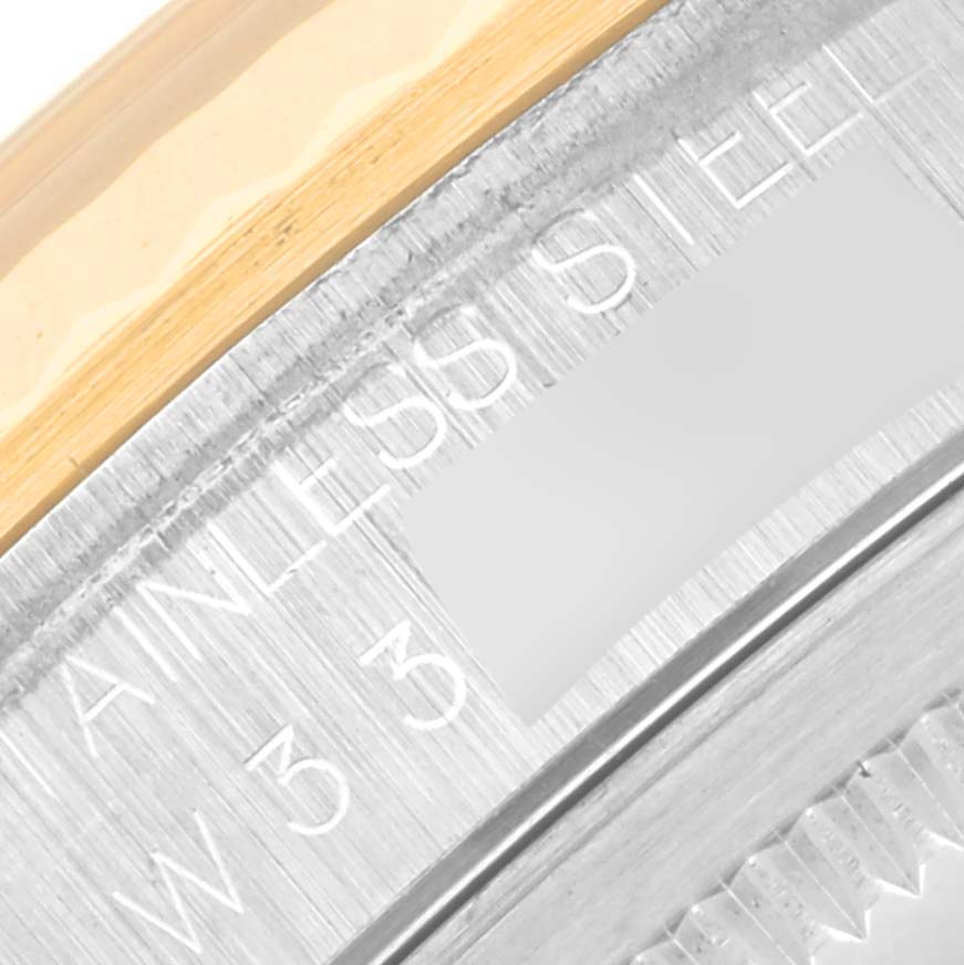 The image shows a close-up of the Rolex Datejust 16233 Men's Steel and Gold (two tone) White Dial 16233 Men's Steel and Gold (two tone) White Dial model's bezel and engraved part in stainless steel.