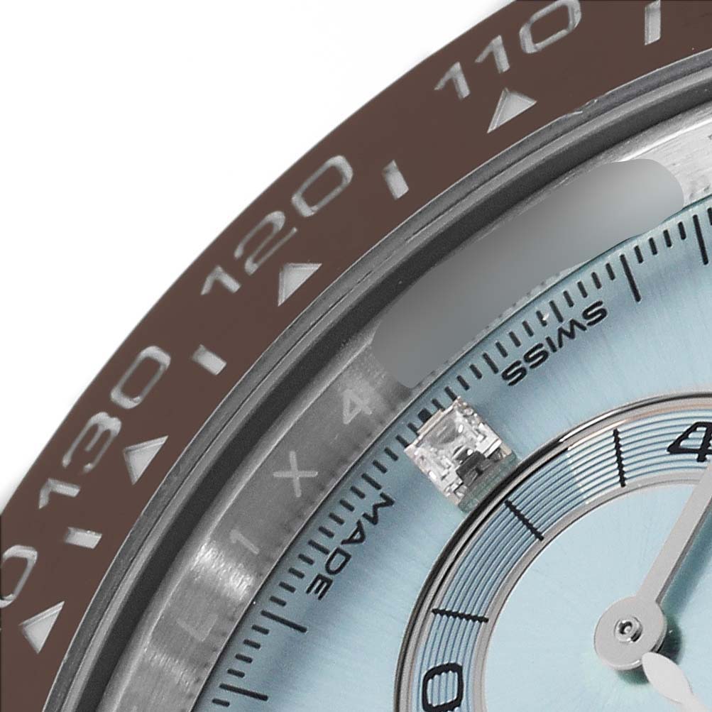 The image shows a close-up of the Rolex Daytona 116506 Men's Platinum Blue Dial 116506 Men's Platinum Blue Dial watch, focusing on the bezel and part of the dial.
