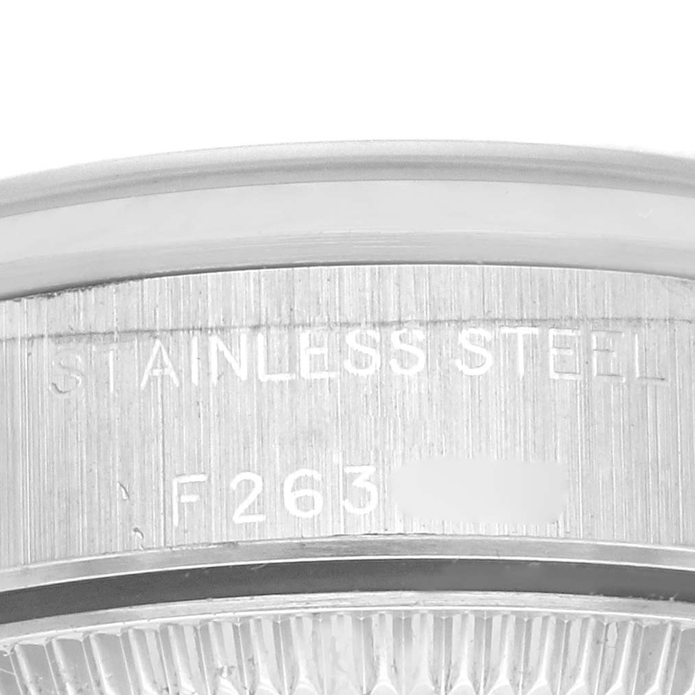 The image shows a close-up of the side of a Rolex Oyster Perpetual 76080 Women's Stainless Steel Pink Dial 76080 Women's Stainless Steel Pink Dial watch, focusing on the stainless steel engraving.