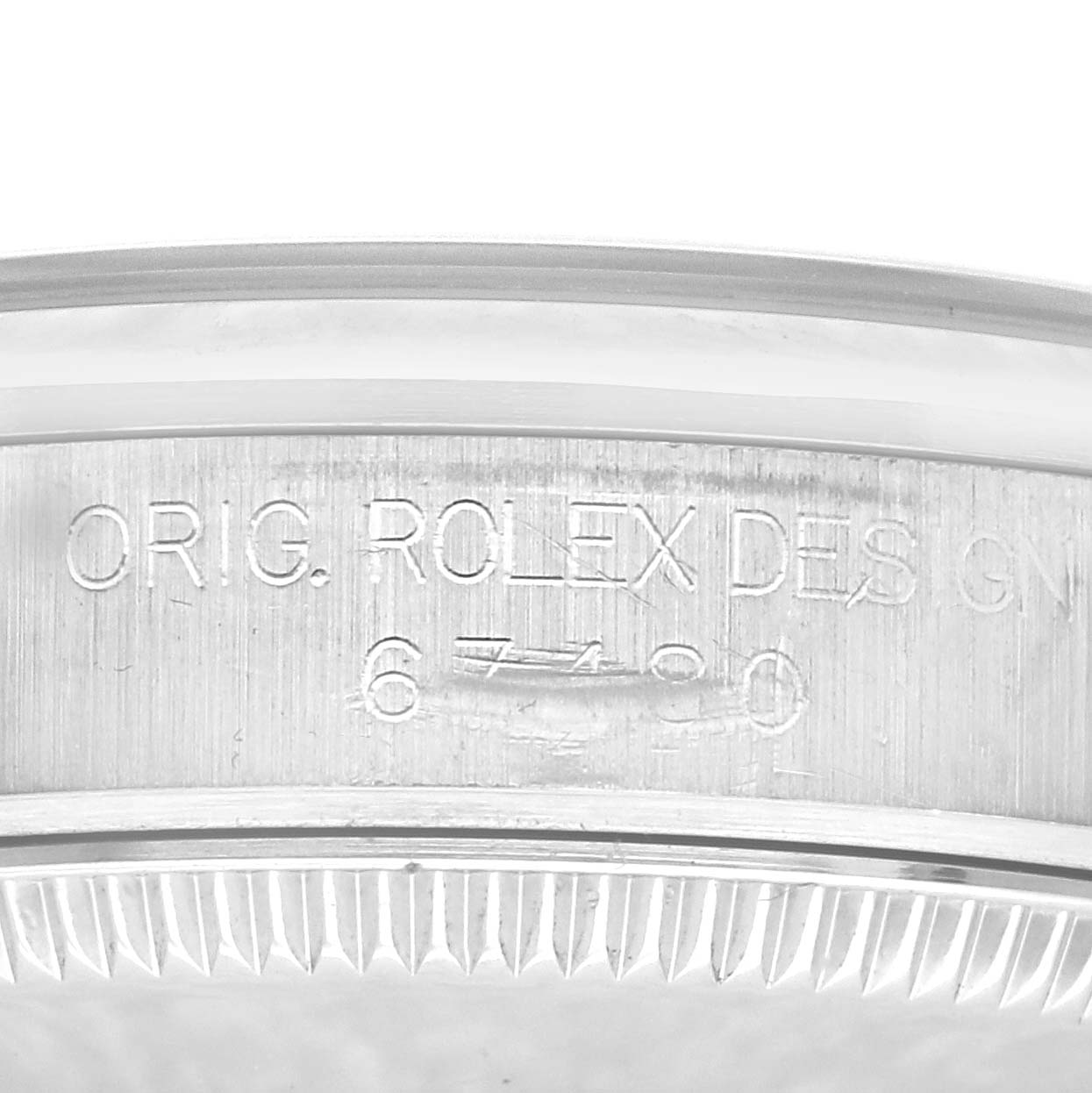The image shows the side view of the Rolex Oyster Perpetual model with the engraved bezel details.