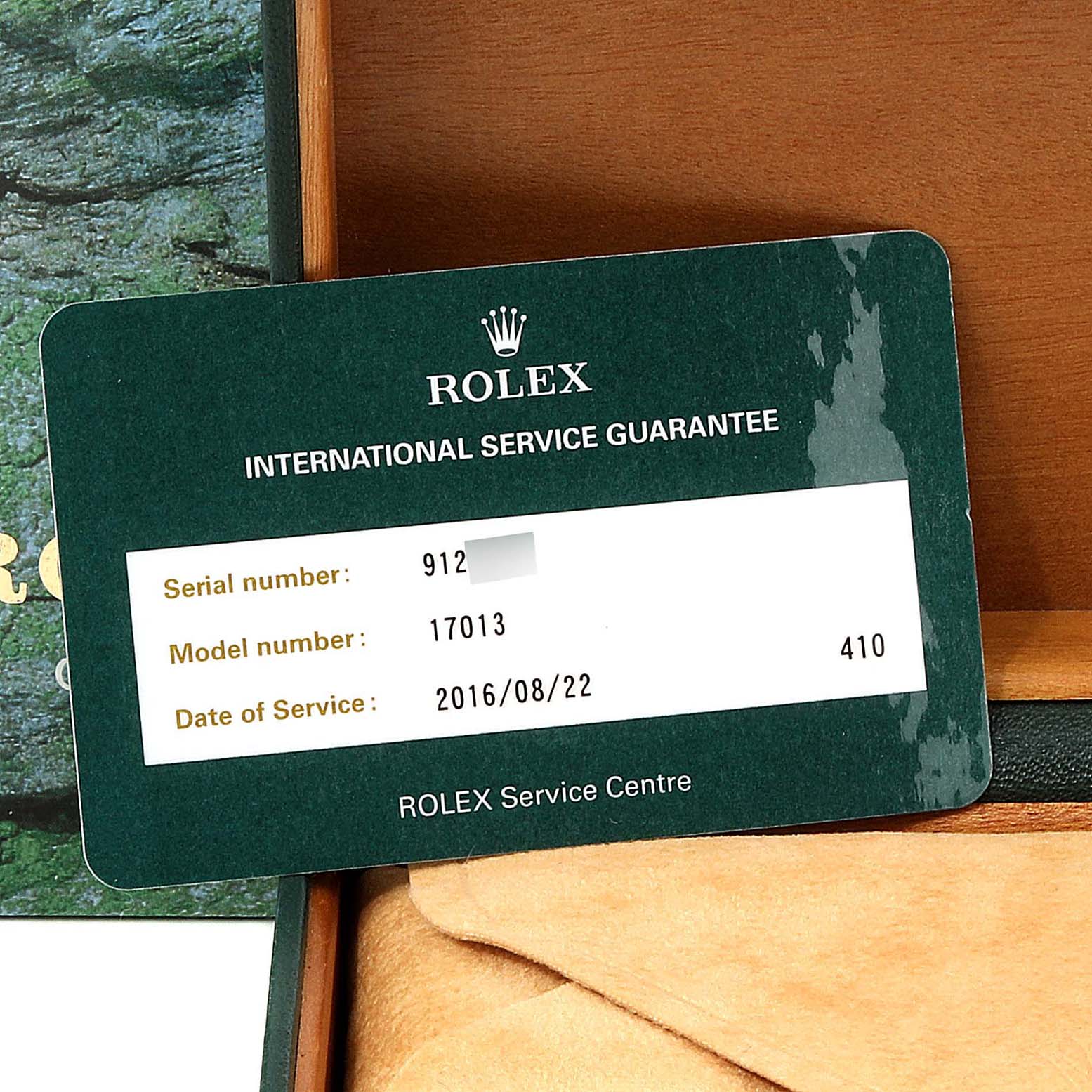 This image shows the Rolex International Service Guarantee card for an Oysterquartz model 17013, serial number partially visible.