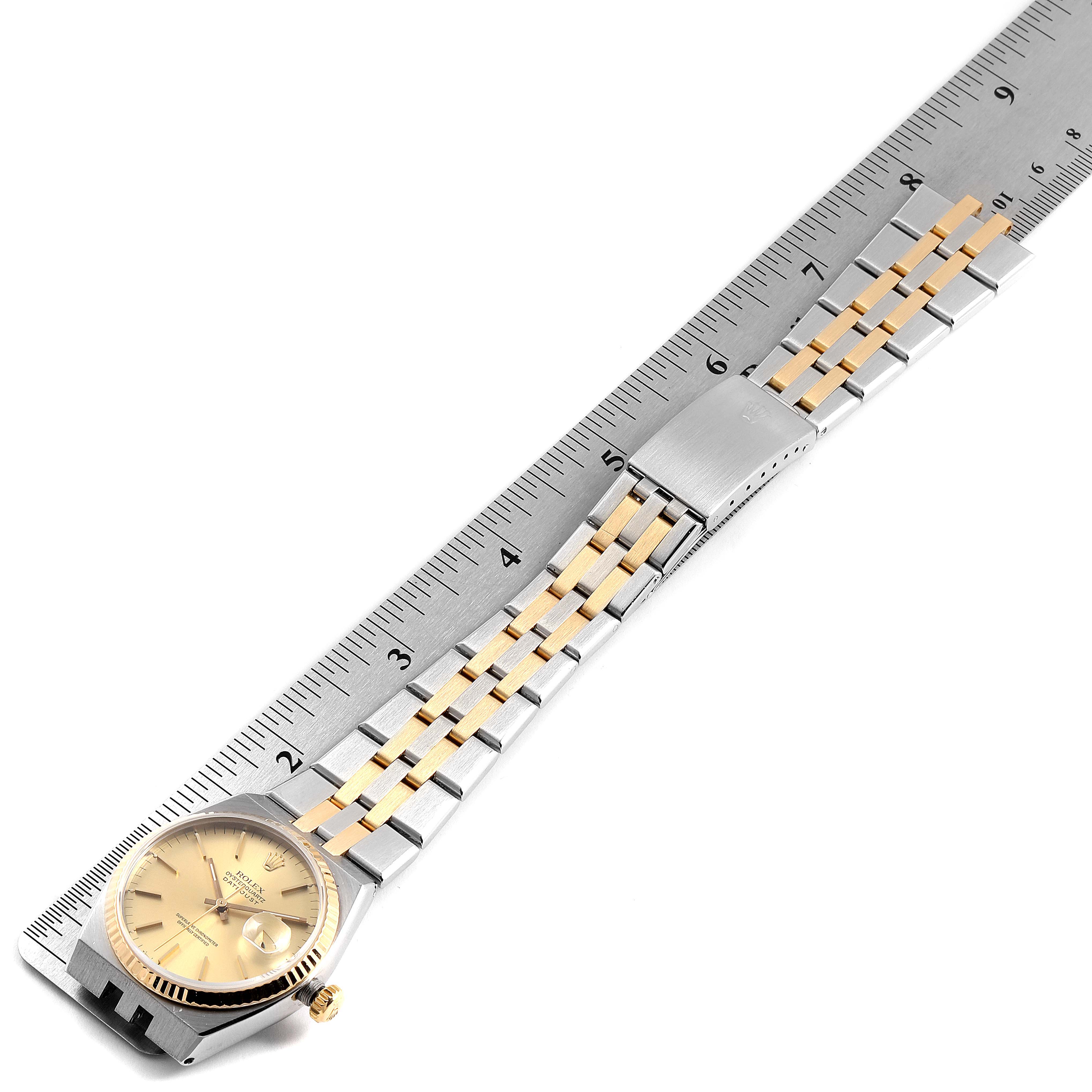 The image shows a Rolex Oysterquartz 17013 Men's Steel and Gold (two tone) Champagne Dial 17013 Men's Steel and Gold (two tone) Champagne Dial watch with a gold dial and a metal bracelet, laid out against a ruler for measurement.