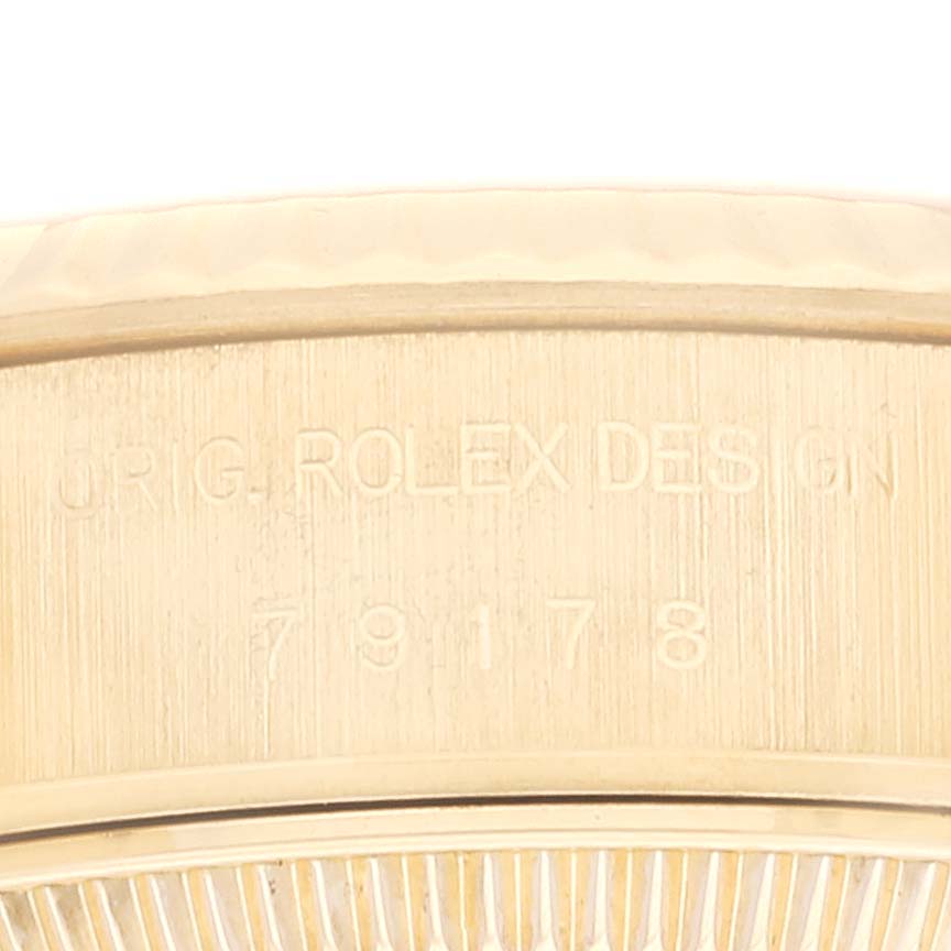 This close-up image shows the engraved serial number and "ORIG. ROLEX DESIGN" on a Rolex President 79178 Women's Yellow Gold Champagne Dial 79178 Women's Yellow Gold Champagne Dial model watch.