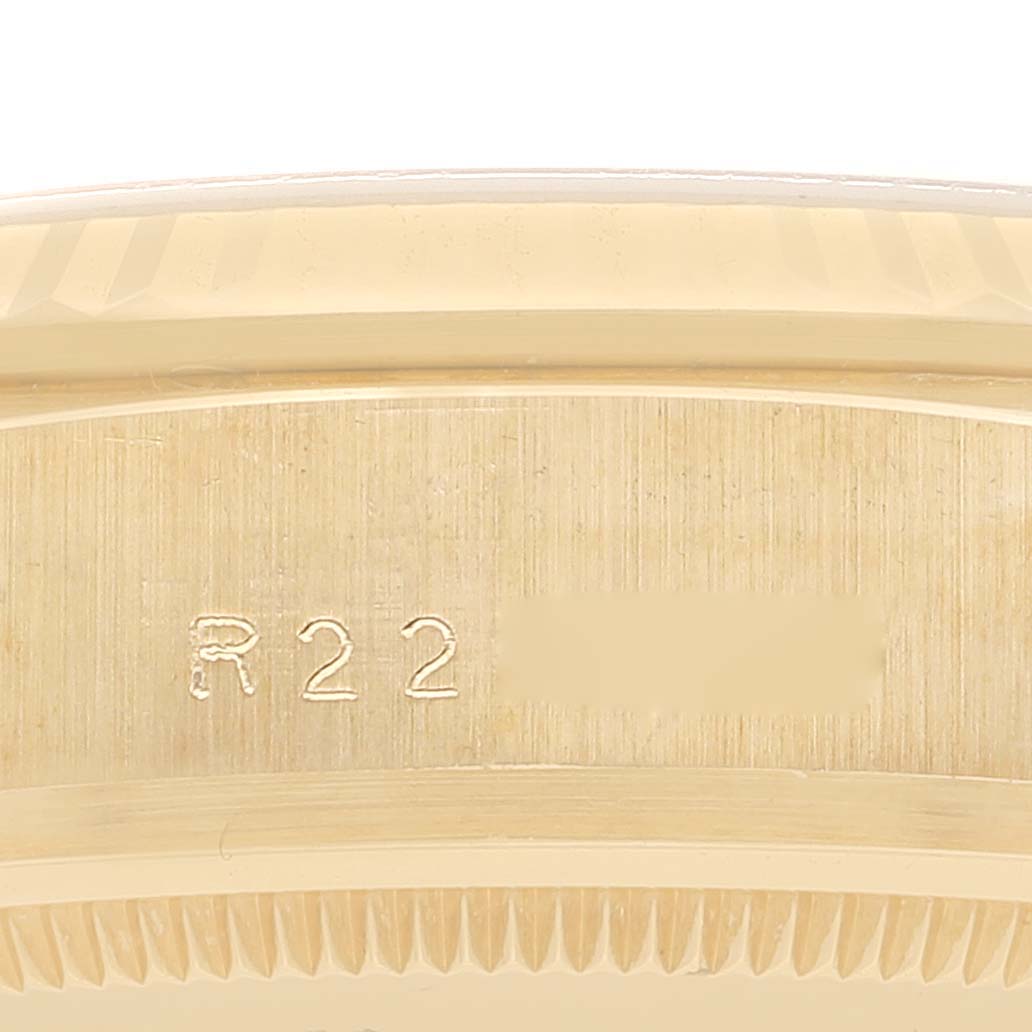 This close-up shows the side of a Rolex President 18038 Men
s Yellow Gold Champagne Dial 18038 Men
s Yellow Gold Champagne Dial model watch, focusing on the engraved serial number.