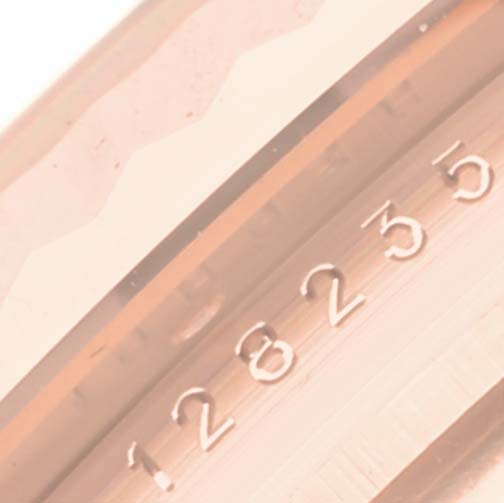 The image shows a close-up of the bezel and edge of the dial on the Rolex President 128235 Men
s Rose Gold Brown Dial 128235 Men
s Rose Gold Brown Dial model.