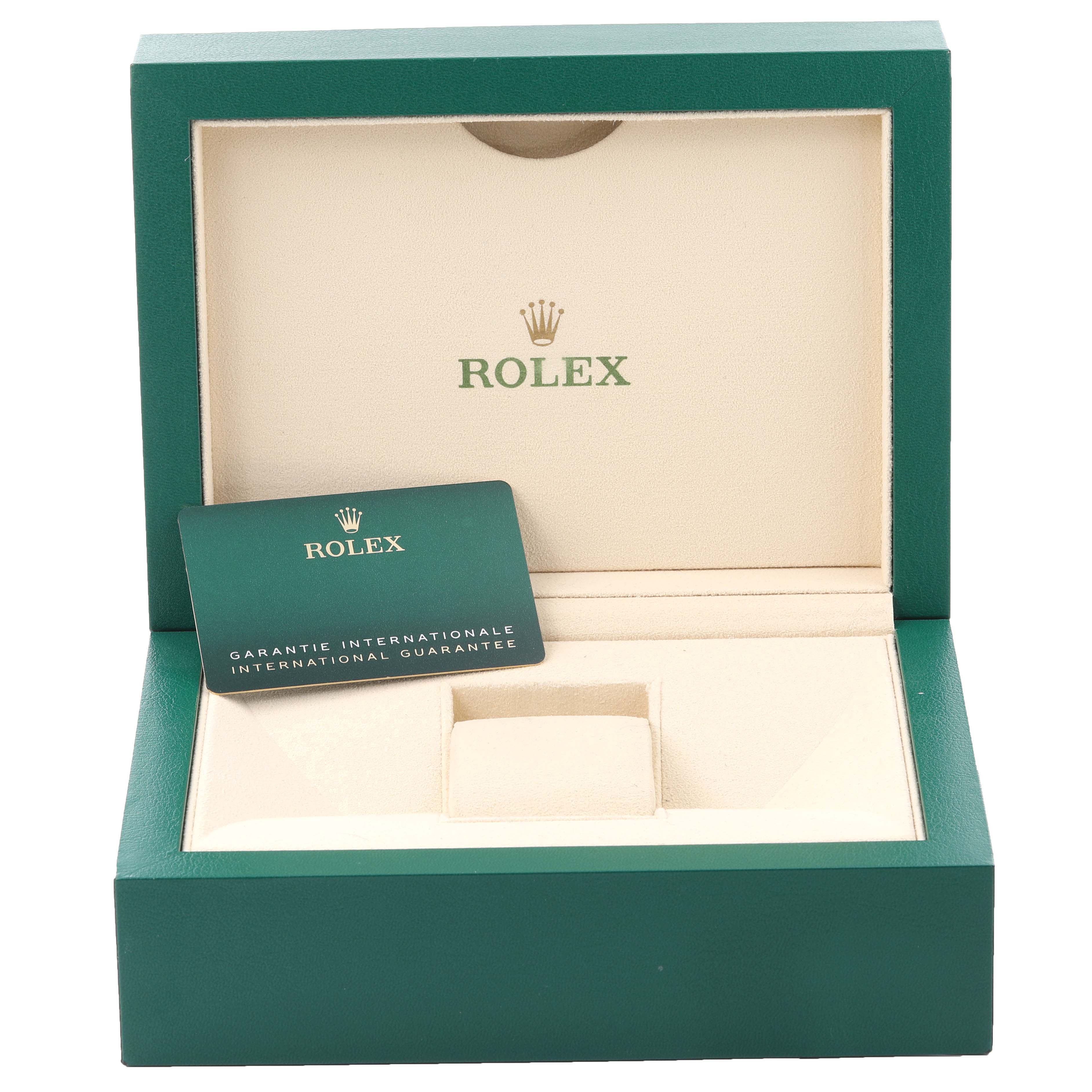 The image shows the open box of a Rolex President 128235 Men
s Rose Gold Brown Dial 128235 Men
s Rose Gold Brown Dial watch with a warranty card inside.