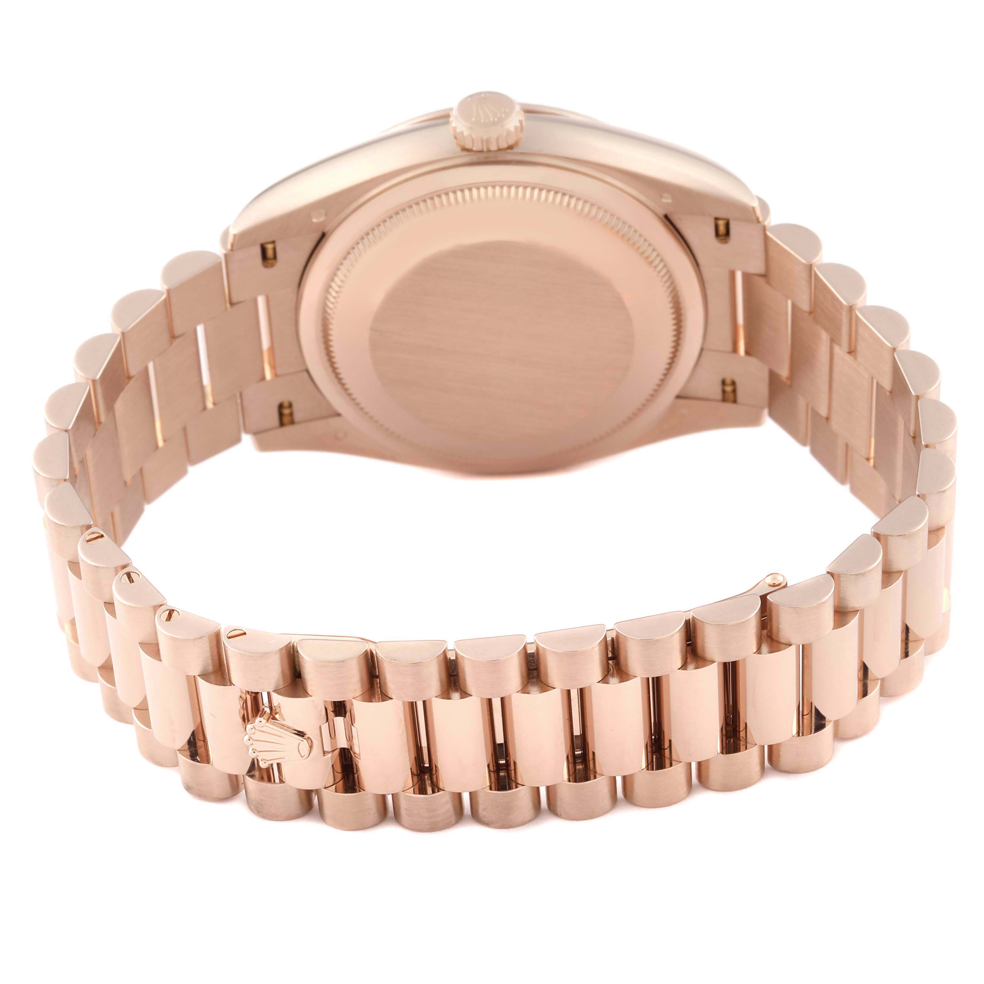 The Rolex President 128235 Men
s Rose Gold Brown Dial 128235 Men
s Rose Gold Brown Dial model watch is shown from the back, highlighting the bracelet and case back.