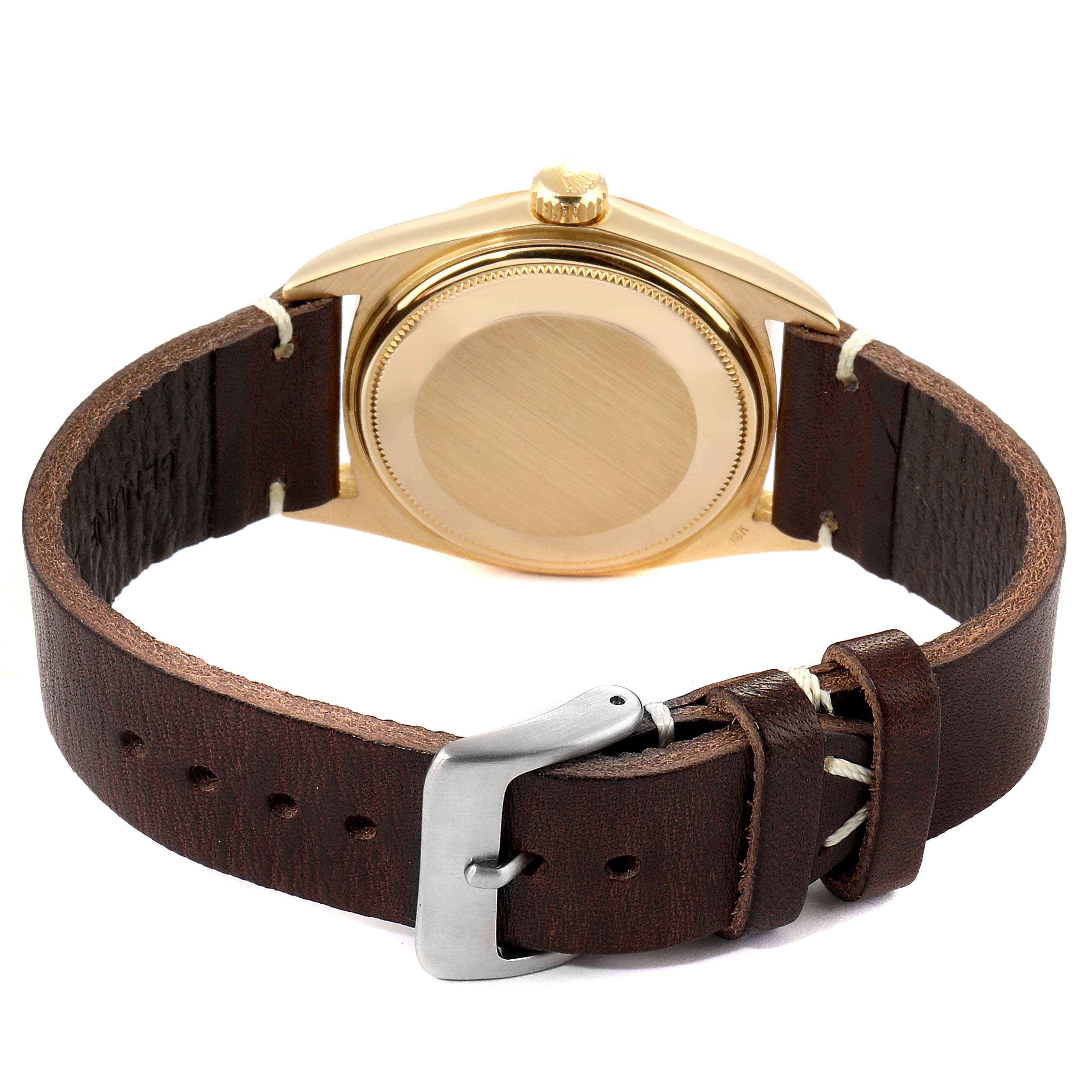 This image shows the back case, crown, and leather strap of a Rolex President 1803 Men
s Yellow Gold Silver Dial 1803 Men
s Yellow Gold Silver Dial model watch.