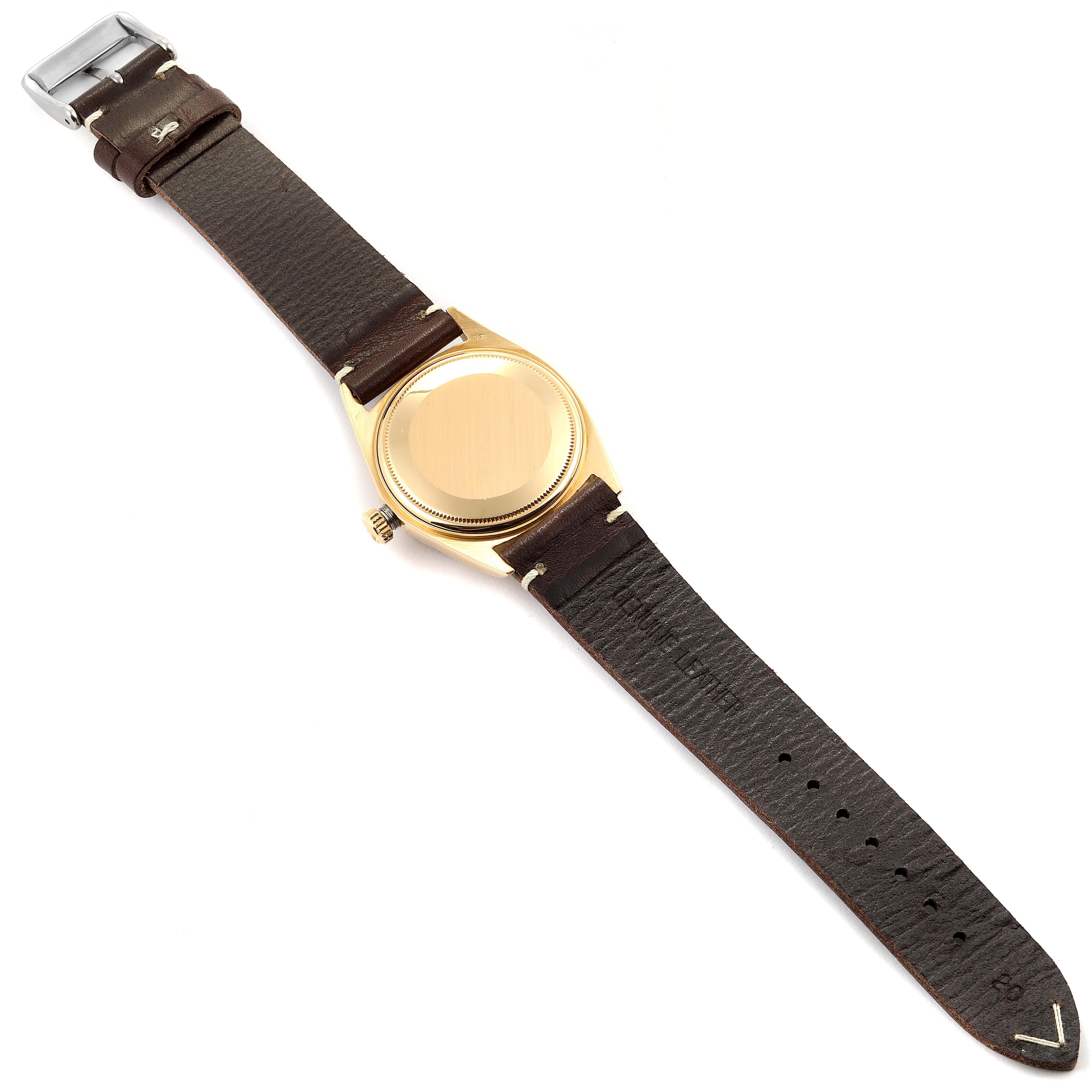 This image shows the back view of a Rolex President 1803 Men
s Yellow Gold Silver Dial 1803 Men
s Yellow Gold Silver Dial model watch, including its brown leather strap and gold case back.