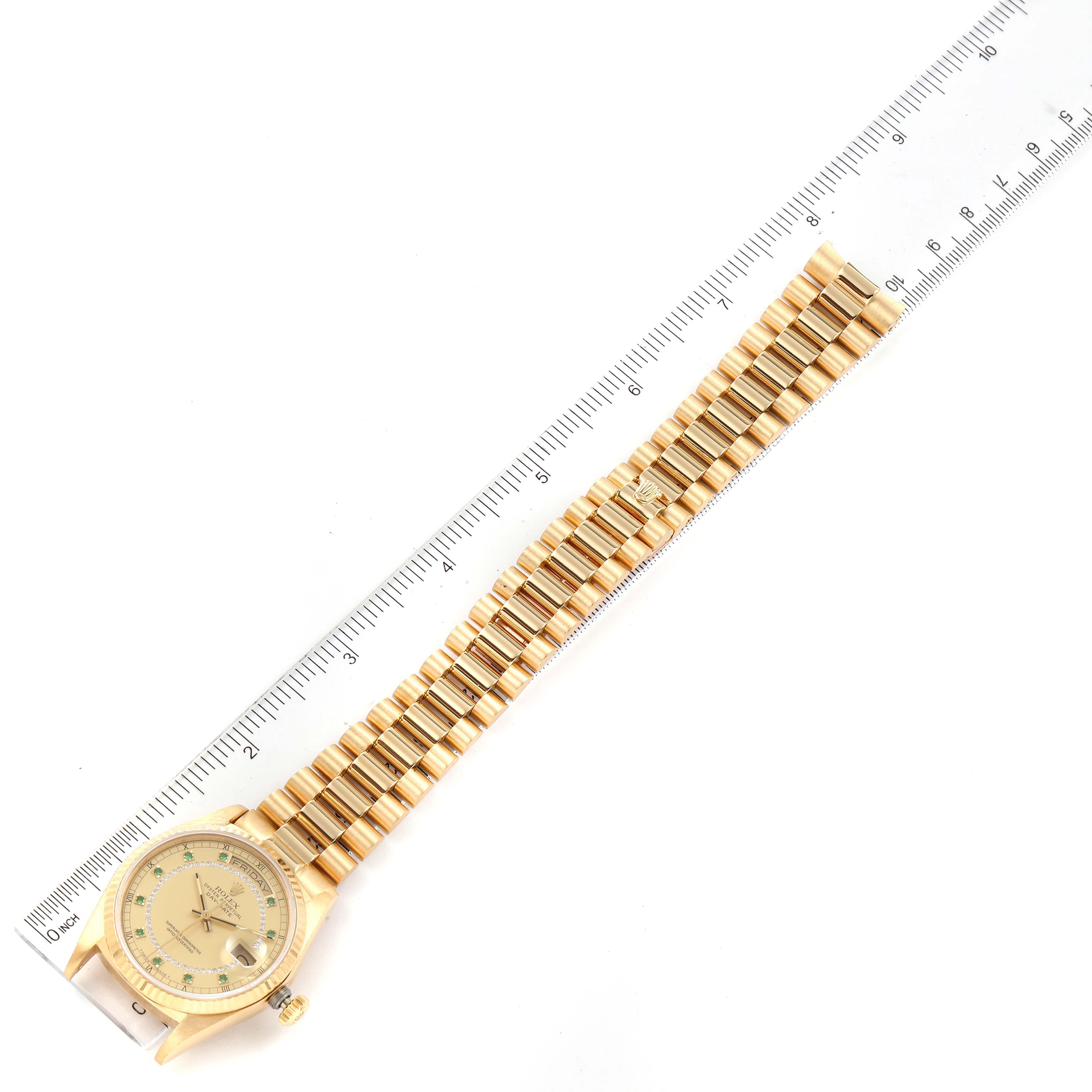 The Rolex President 18038 Men
s Yellow Gold Champagne Dial 18038 Men
s Yellow Gold Champagne Dial watch is shown from a top-down view, displaying the entire band and face alongside a measuring ruler.
