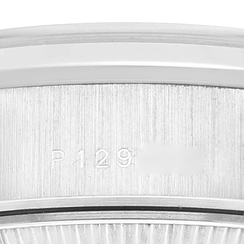 This close-up image shows the side of the bezel and case of a Rolex President 79166 Women's Platinum Silver Dial 79166 Women's Platinum Silver Dial model watch, featuring part of its engraved serial number.
