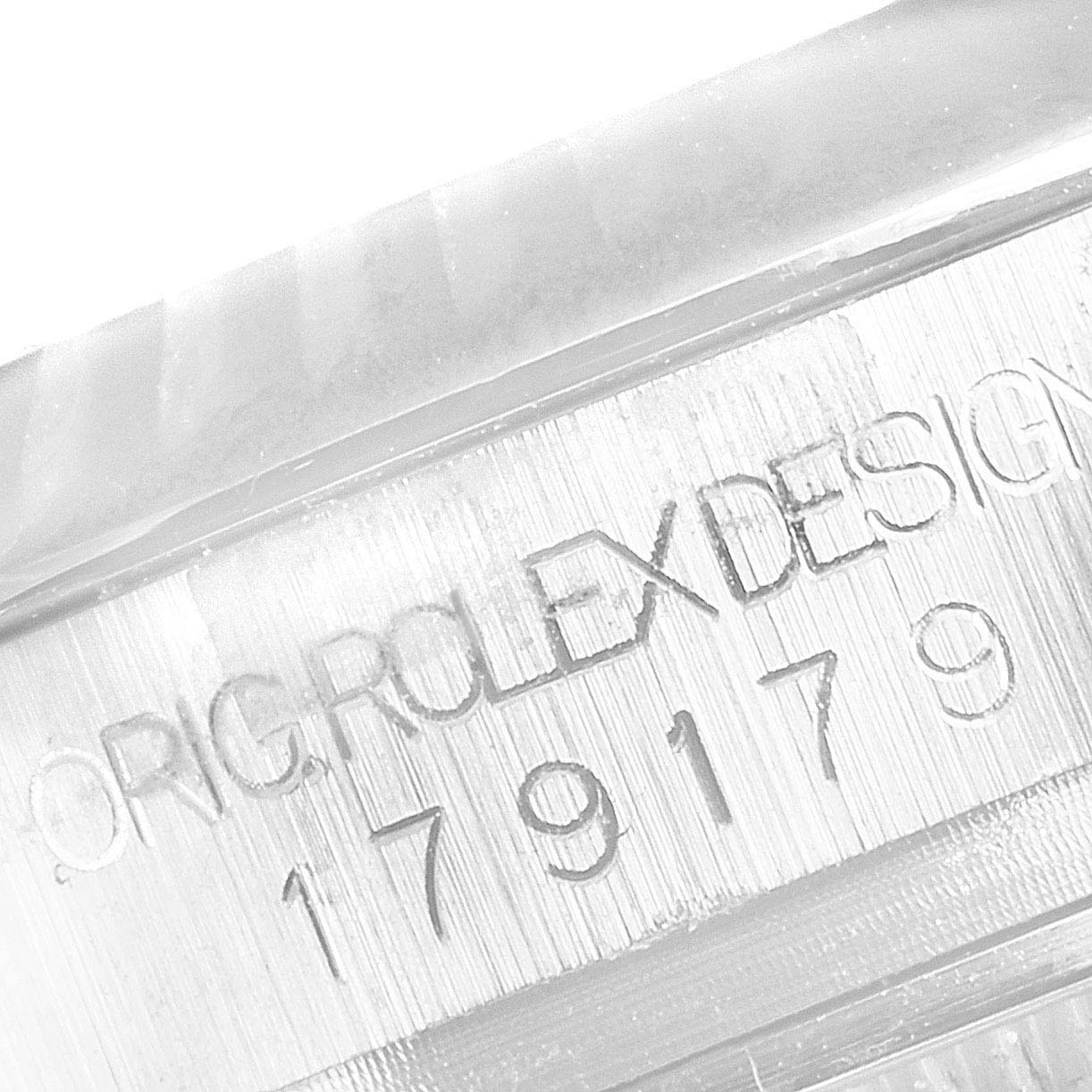 This image shows a close-up of the engraved serial number and "Rolex Design" on a Rolex President 179179 Women's White Gold Silver Dial 179179 Women's White Gold Silver Dial watch.