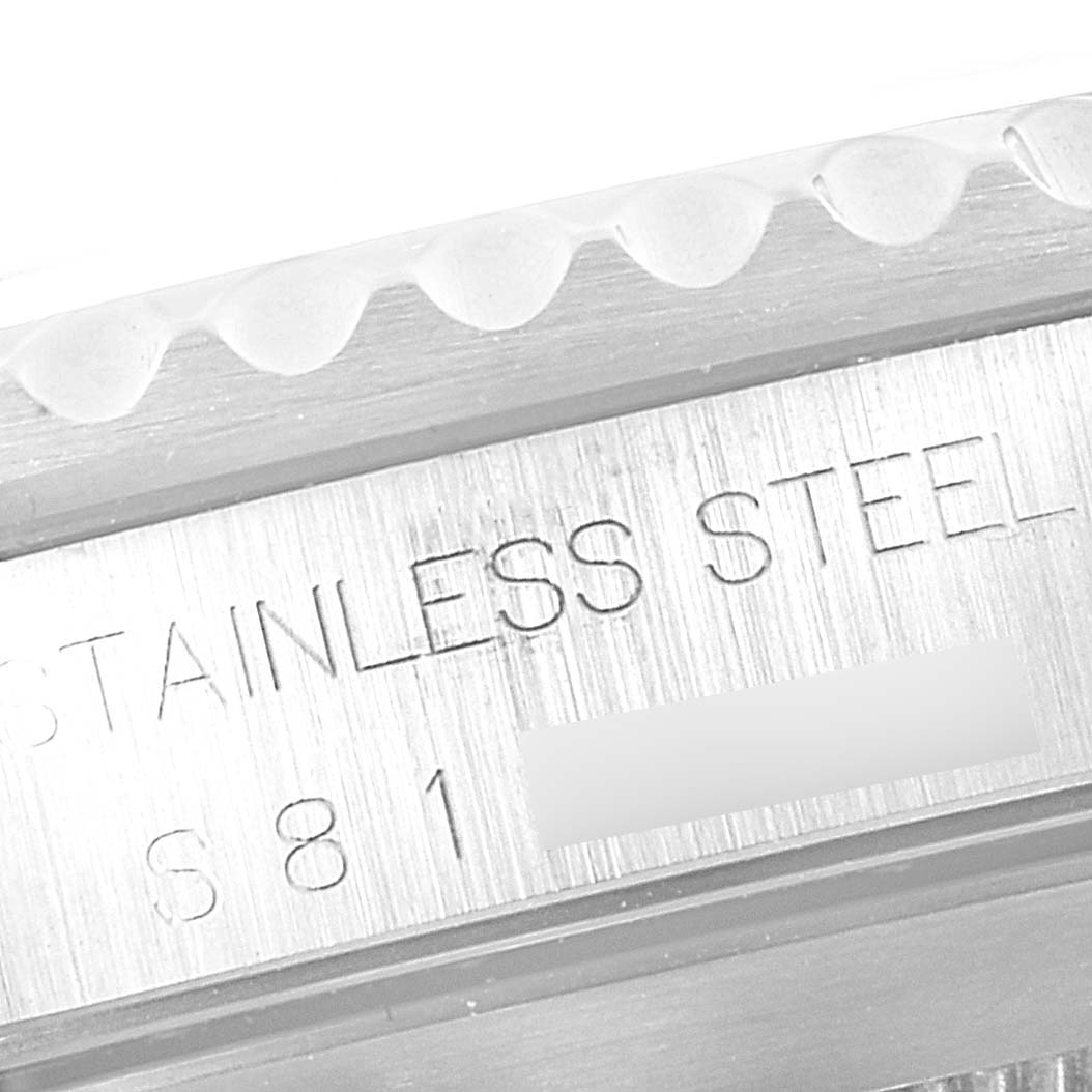 This close-up image shows the engraved side of a Rolex Submariner 14060 Men
s Stainless Steel Black Dial 14060 Men
s Stainless Steel Black Dial watch case, specifically stating "STAINLESS STEEL."