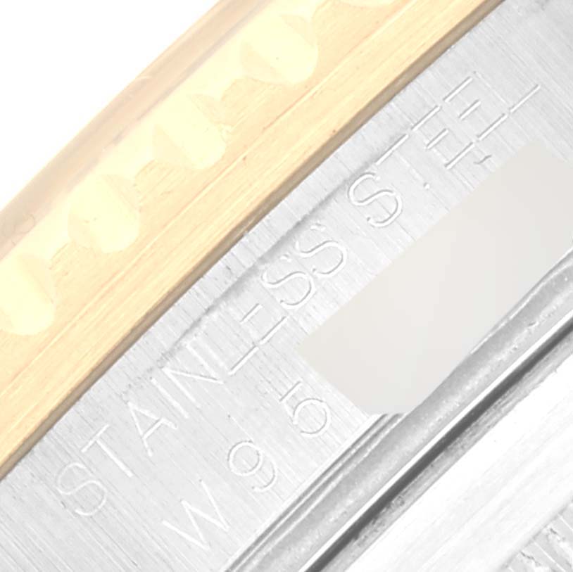 This image shows a close-up of the caseback and part of the bezel of a Rolex Submariner 16613 Men's Steel and Gold (two tone) Blue Dial 16613 Men's Steel and Gold (two tone) Blue Dial watch, highlighting the "STAINLESS STEEL" engraving.