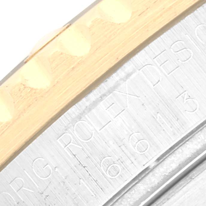 This close-up image shows the bezel and part of the engraved inner ring of a Rolex Submariner 16613 Men's Steel and Gold (two tone) Blue Dial 16613 Men's Steel and Gold (two tone) Blue Dial watch.
