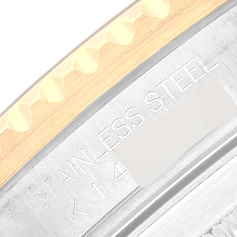 The image shows a close-up of the casing of a Rolex Submariner 16613 Men's Steel and Gold (two tone) Blue Dial 16613 Men's Steel and Gold (two tone) Blue Dial watch, highlighting the stainless steel and gold bezel.