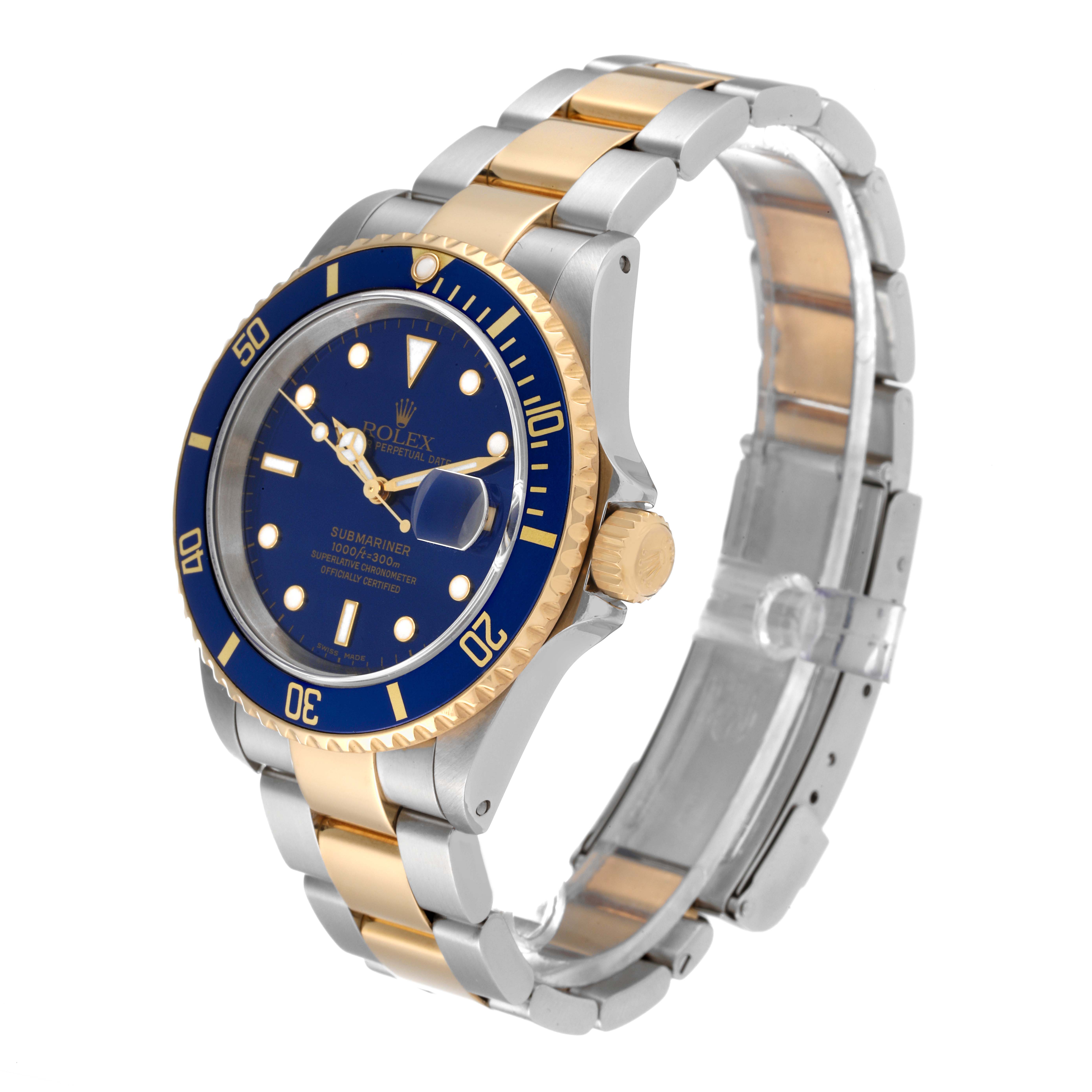 The image shows a Rolex Submariner 16613 Men's Steel and Gold (two tone) Blue Dial 16613 Men's Steel and Gold (two tone) Blue Dial watch at a 3/4 angle, highlighting the blue dial, bezel, and two-tone metal bracelet.