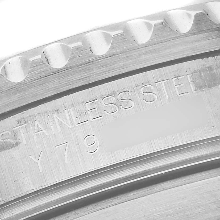 The image shows a close-up of the bezel edge and engraved text on the Rolex Submariner 16610 Men
s Stainless Steel Black Dial 16610 Men
s Stainless Steel Black Dial
s stainless steel case back.