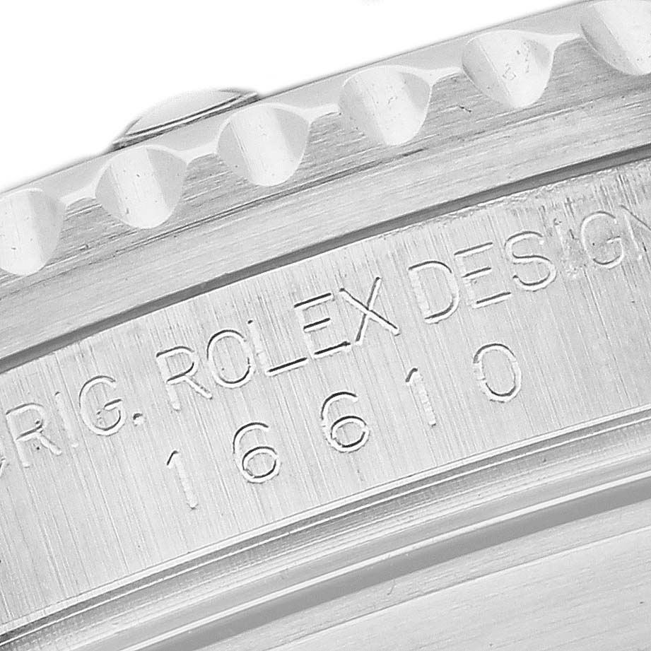 The image shows a close-up of the engravings on the side of a Rolex Submariner 16610 Men
s Stainless Steel Black Dial 16610 Men
s Stainless Steel Black Dial watch case.