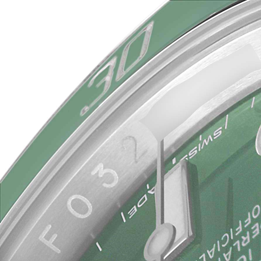 This close-up image shows the bezel and part of the dial of a Rolex Submariner 116610LV Men
s Stainless Steel Green Dial 116610LV Men
s Stainless Steel Green Dial watch. 