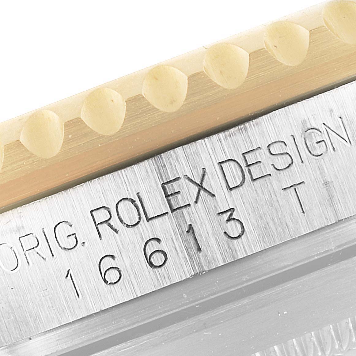 The image shows a close-up of the bezel and engraved case side of a Rolex Submariner 16613 Men
s Steel and Gold (two tone) Champagne Dial 16613 Men
s Steel and Gold (two tone) Champagne Dial.