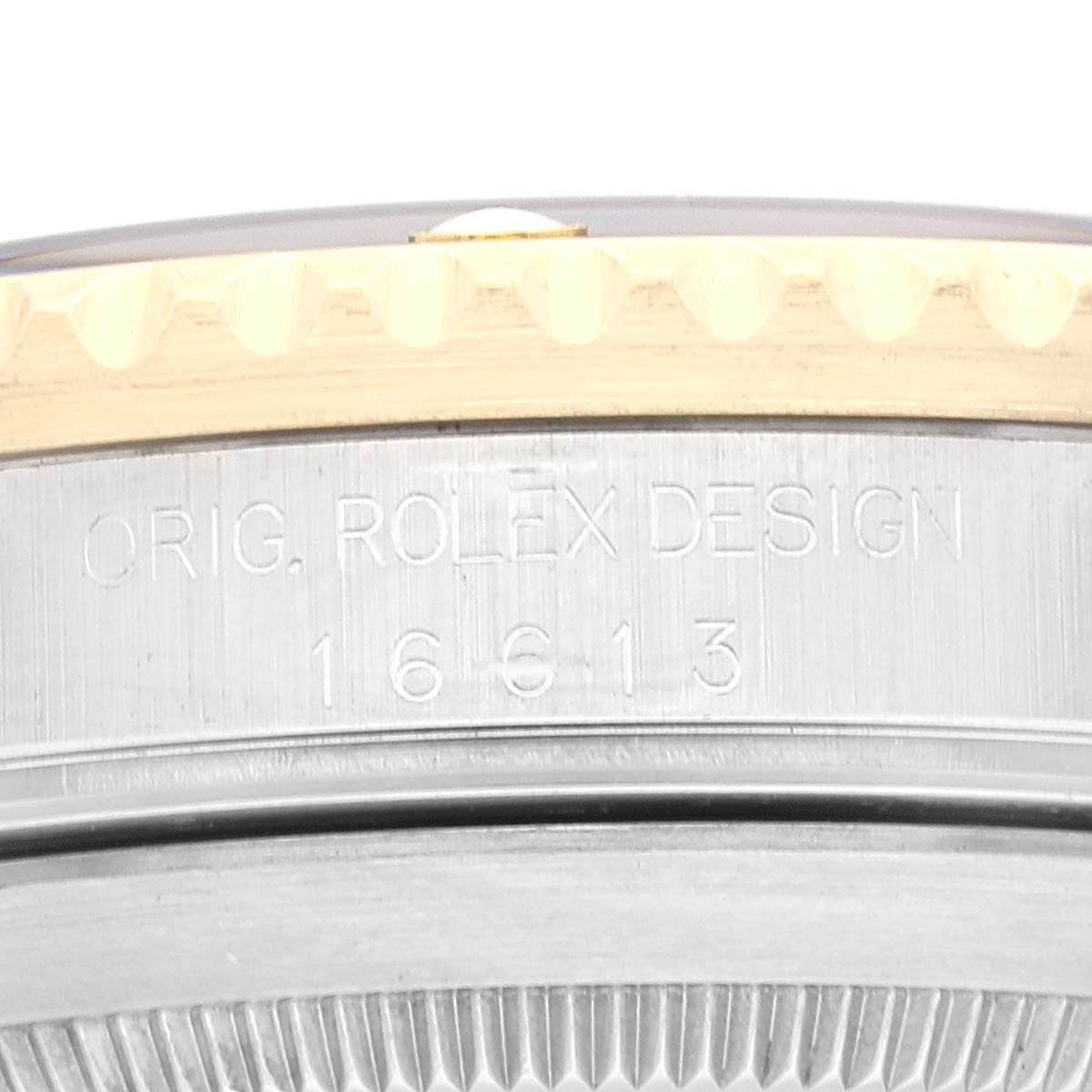 The image shows a close-up of the case side of a Rolex Submariner 16613 Men's Steel and Gold (two tone) Black Dial 16613 Men's Steel and Gold (two tone) Black Dial, displaying the "ORIG. ROLEX DESIGN" engraving and model number, 16613.
