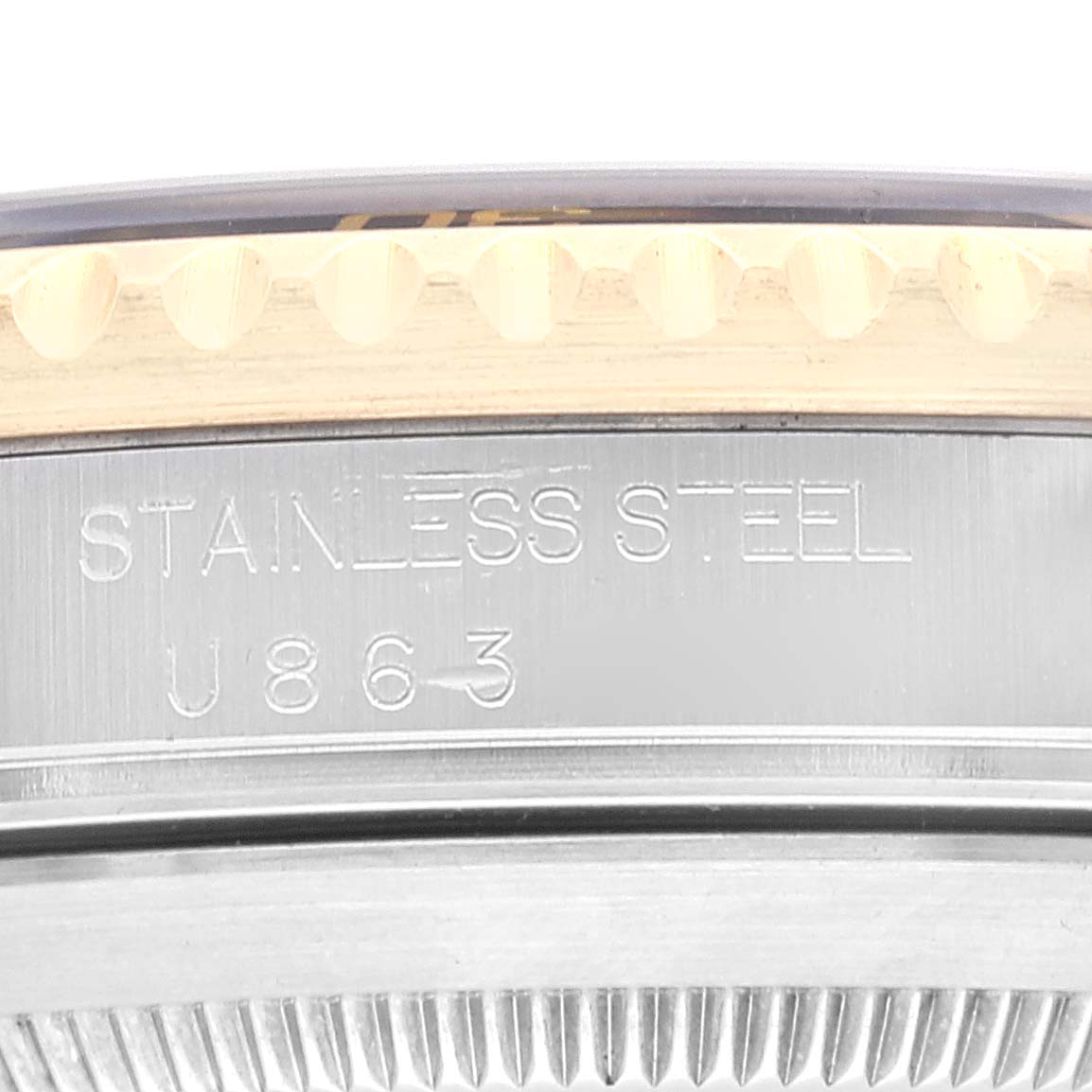 This close-up angle shows the side of the case and part of the bezel of the Rolex Submariner 16613 Men's Steel and Gold (two tone) Black Dial 16613 Men's Steel and Gold (two tone) Black Dial, highlighting the "Stainless Steel" engraving.