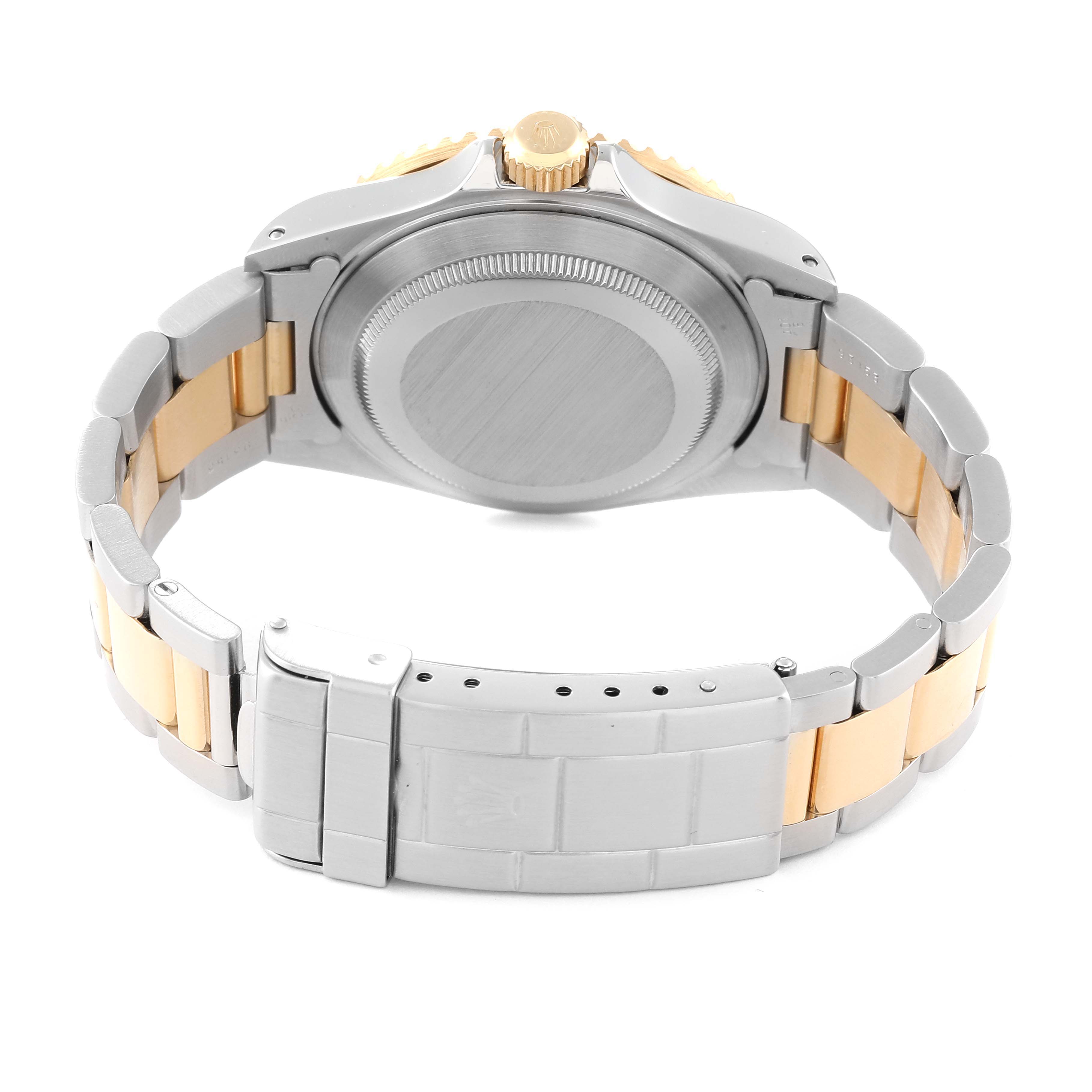 This image shows the rear view of a Rolex Submariner 16613 Men's Steel and Gold (two tone) Black Dial 16613 Men's Steel and Gold (two tone) Black Dial watch, highlighting its case back and two-tone bracelet.