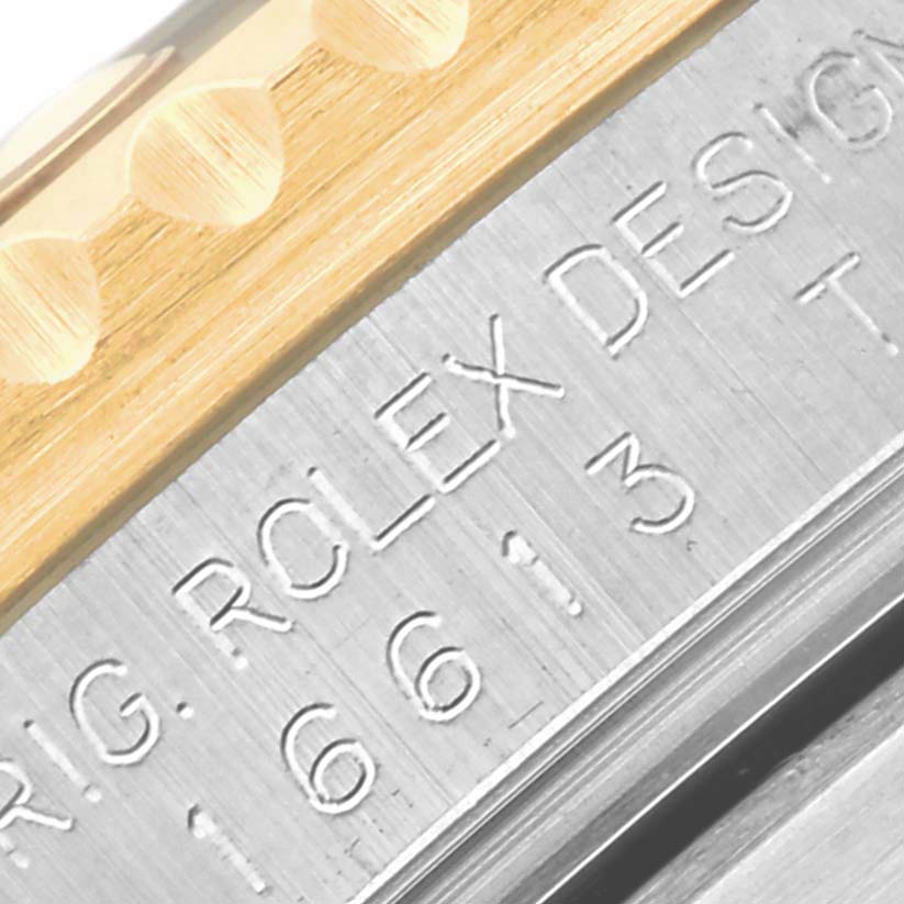 This close-up shows the engraved side of a Rolex Submariner 16613 Men's Steel and Gold (two tone) Black Dial 16613 Men's Steel and Gold (two tone) Black Dial watch bezel and case edge.