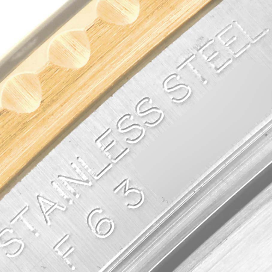 The image shows a close-up of the engraved casing edge of a Rolex Submariner 16613 Men's Steel and Gold (two tone) Black Dial 16613 Men's Steel and Gold (two tone) Black Dial watch, highlighting "STAINLESS STEEL."