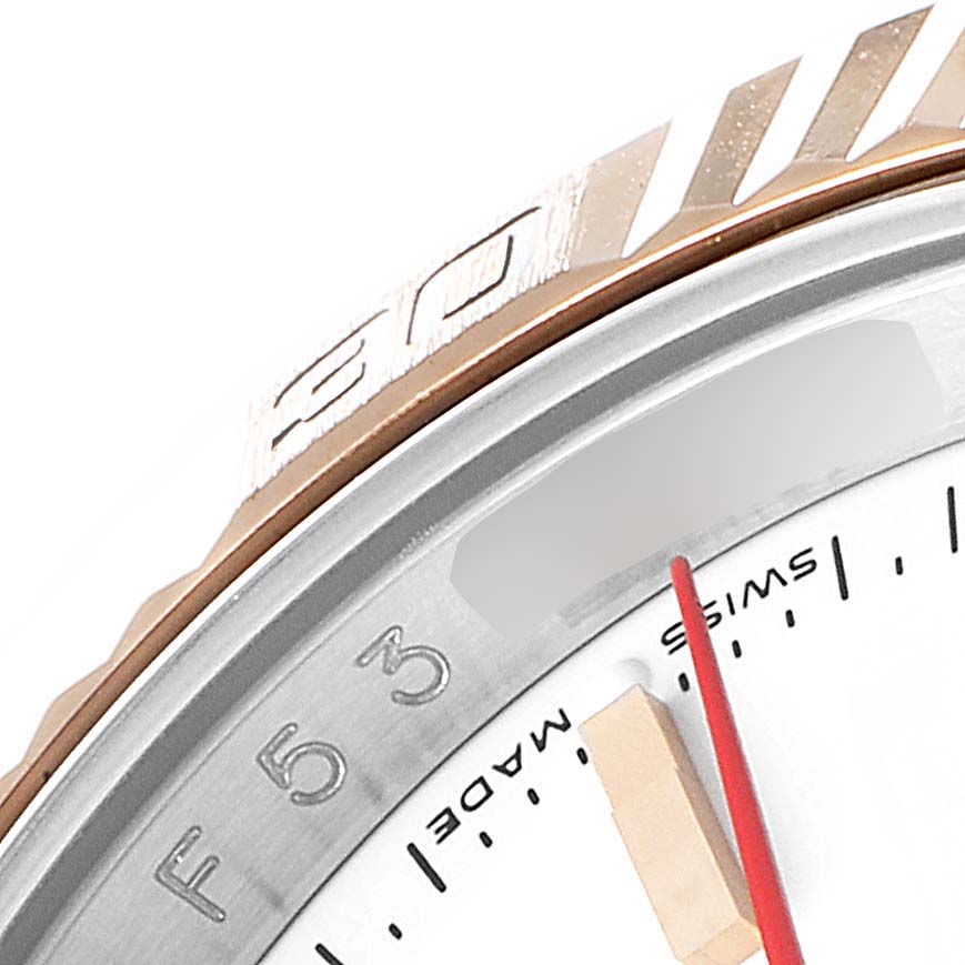 This close-up image of the Rolex Turn-o-Graph 116261 Men
s Steel and Gold (two tone) White Dial 116261 Men
s Steel and Gold (two tone) White Dial model shows the bezel, part of the dial, the minute hand, and some markings.