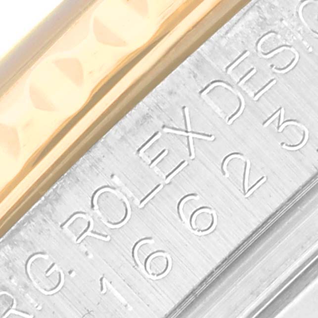 The image shows a close-up of the edge and engraving on a Rolex Yacht-Master 16623 Men
s Steel and Gold (two tone) Blue Dial 16623 Men
s Steel and Gold (two tone) Blue Dial
s case.